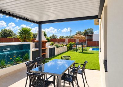Porche con pérgola, mesa exterior y barbacoa del Apartamento Buenavista Jardín